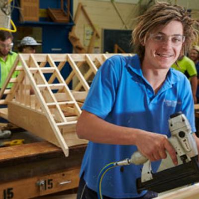 Carpenter drilling into a piece of wood