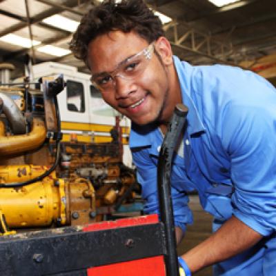 Aboriginal apprentice working on a heavy machine