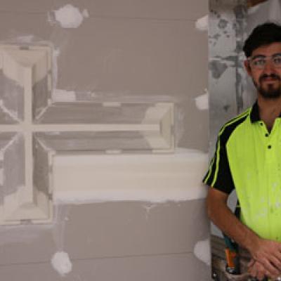 Wall and Ceiling plasterer posing with his plaster cornice work