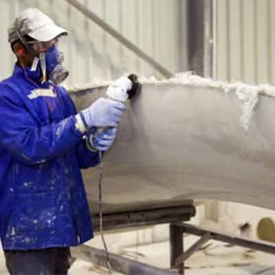 Person sanding a ship hull