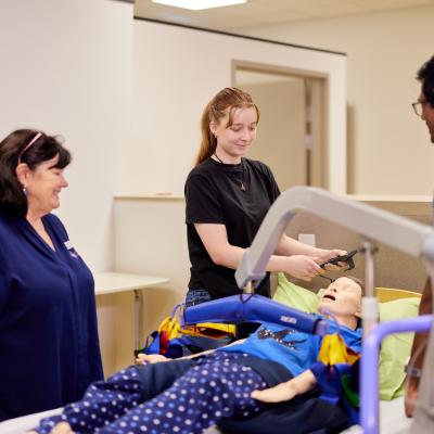Lecturer and two students completing a task