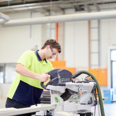 Student using a carpentry machine