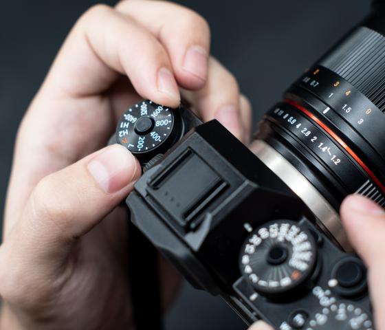 Close up of a hand holding a digital camera