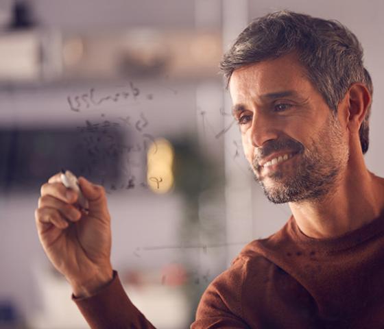 person writing calculations on glass window for Applied Engineering Mathematics skill set