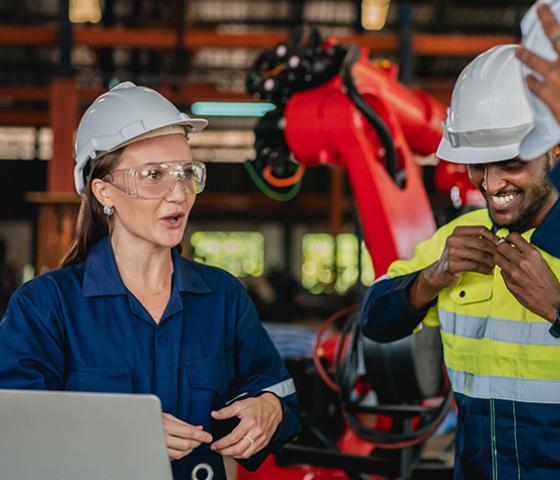 Two colleagues equip safety gear.