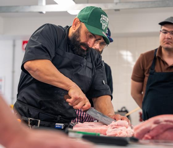 lecturer demonstrating slicing meat 