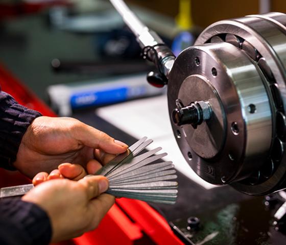 person operating engineering equipment lathe