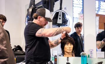 Barbering student cutting hair during Worldskills competition 