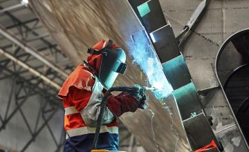 Student in Personal Protective Equipment doing welding 